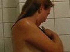 Girlie doesn't shy to be filmed on camera naked. She continues showering, when her guy enters bathroom.